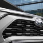 Close-up of a silver Toyota vehicle's front grille, highlighting the design and logo, relevant to transmission issues in the UA80 model.