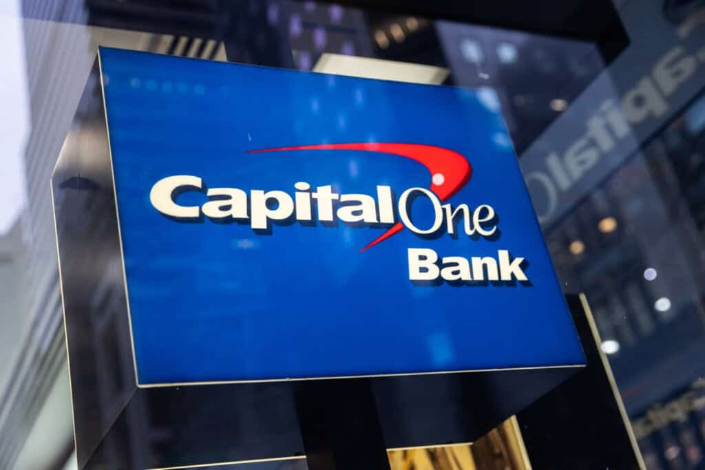 Capital One Bank sign displayed outdoors, featuring the bank's logo on a blue background, related to financial services and banking.