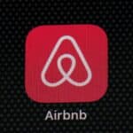 Airbnb app icon on a smartphone screen, related to legal issues and regulations in New Orleans.