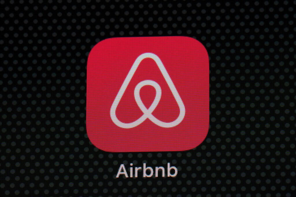 Airbnb app icon on a smartphone screen, related to legal issues and regulations in New Orleans.