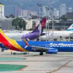 Southwest Airlines aircraft on the runway with other planes at a busy airport, highlighting airline operations and aviation safety.