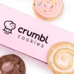 Close-up of Crumbl Cookies packaging with logo, highlighting legal issues related to copyright lawsuit.