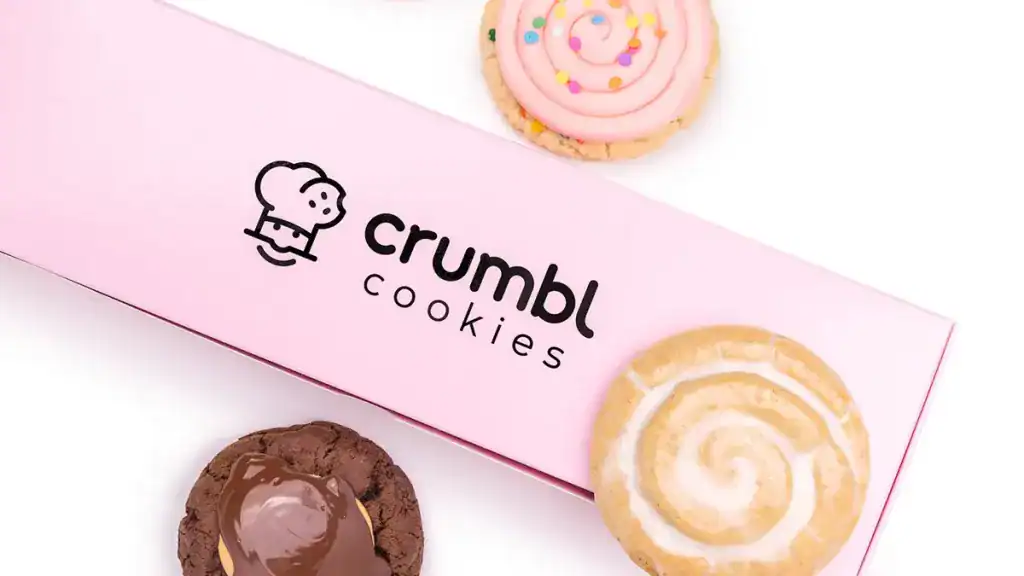 Close-up of Crumbl Cookies packaging with logo, highlighting legal issues related to copyright lawsuit.