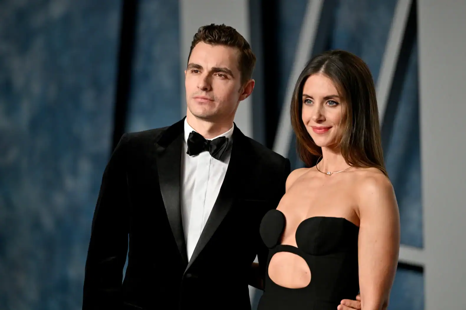 A well-dressed man and woman attending the Together Lawsuit event, showcasing professionalism and style at a formal legal gathering.