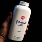 Close-up of Johnson's baby powder bottle, emphasizing the product's branding and packaging.