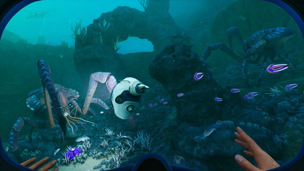 An underwater scene from Subnautica featuring a diver's hands exploring vibrant marine life and alien creatures.