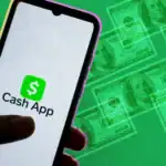 Image showing a smartphone with the Cash App logo and fake money, highlighting issues related to Cash App scam texts and legal actions.