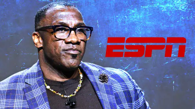 Shannon Sharpe in a blue checkered blazer speaking at a legal event, highlighting a lawsuit related to OnlyFans.