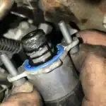 Close-up of GM CP4 fuel pump showing installation details, relevant for GM fuel pump lawsuit cases.