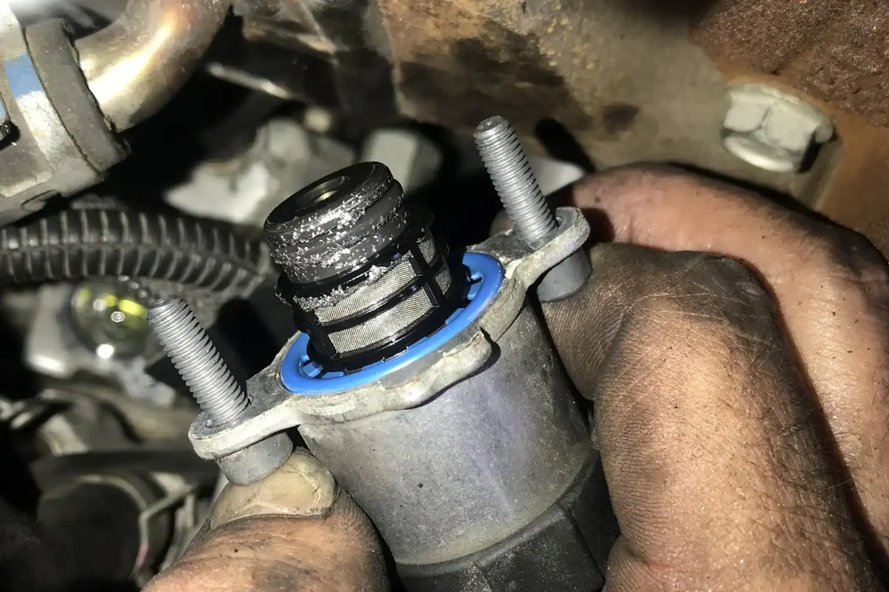 Close-up of GM CP4 fuel pump showing installation details, relevant for GM fuel pump lawsuit cases.