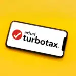Smartphone displaying TurboTax logo on a yellow background, highlighting tax software issues and legal concerns for 2025.